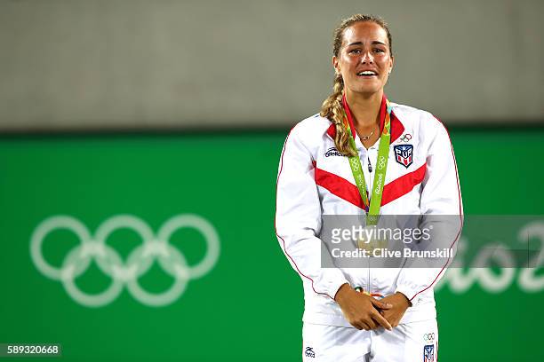 Gold medalist Monica Puig of Puerto Rico poses during the medal ceremony for Women's Singles on Day 8 of the Rio 2016 Olympic Games at the Olympic...