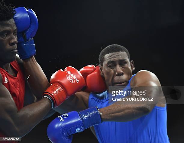 Nigeria's Efe Ajagba lands a punch on Trinidad and Tobago's Nigel Paul during the Men's Super Heavy at the Rio 2016 Olympic Games at the Riocentro -...