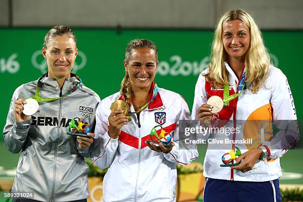 Silver medalist Angelique Kerber of Germany, gold medalist Monica Puig of Puerto Rico and bronze medalist Petra Kvitova of the Czech Republic pose...