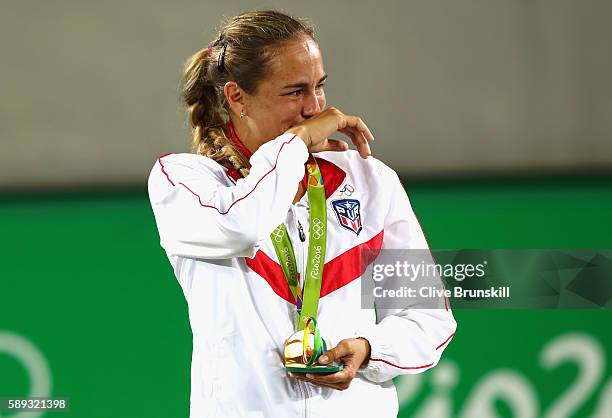 Gold medalist Monica Puig of Puerto Rico reacts during the medal ceremony for Women's Singles on Day 8 of the Rio 2016 Olympic Games at the Olympic...