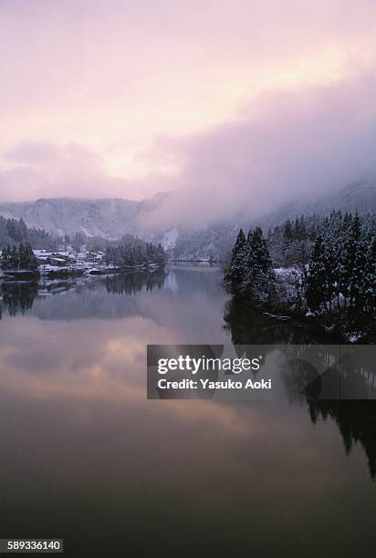 the sun setting over agano river during winter. niigata prefecture, japan - niigata stock pictures, royalty-free photos & images