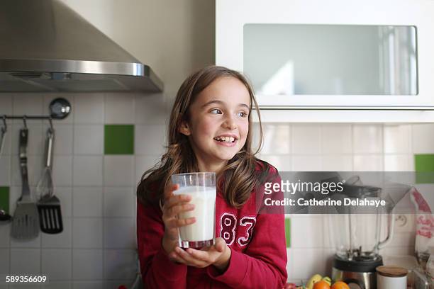 a 10 years old girl with a glass of milk - 10 years old girls stock pictures, royalty-free photos & images