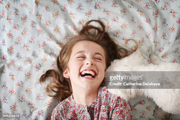 a 10 years old girl laughing with her dog - girl 10 years old happy stock-fotos und bilder
