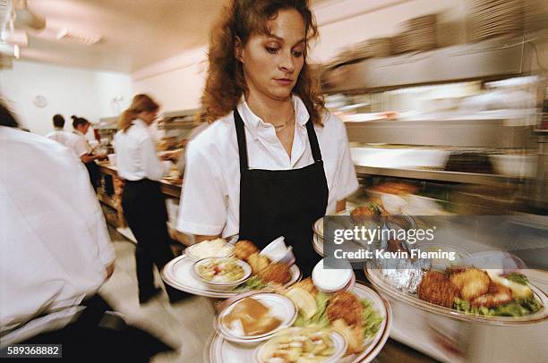 waitress carrying plates of food - overworked waitress stock pictures, royalty-free photos & images