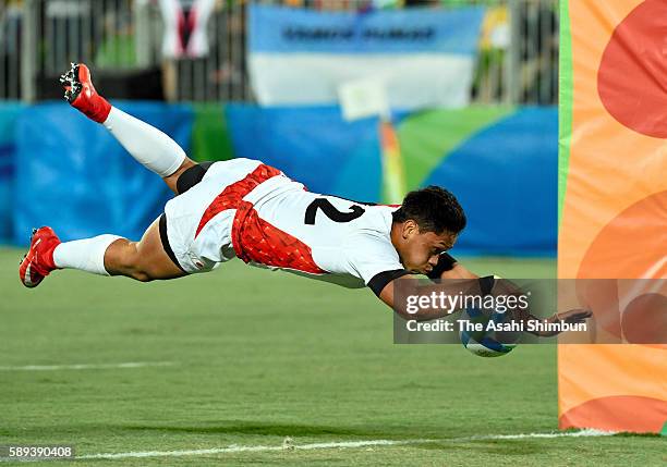 Kazuhiro Goya of Japan dives to score a try during the Men's Rugby Sevens Bronze medal final match between Japan and South Africa on Day 6 of the Rio...