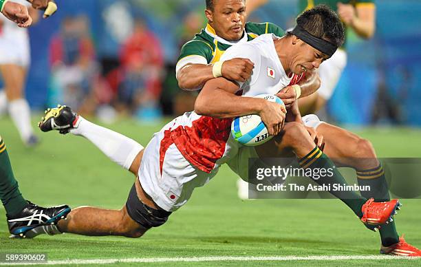 Yusaku Kuwazuru of Japan is tackled during the Men's Rugby Sevens Bronze medal final match between Japan and South Africa on Day 6 of the Rio 2016...