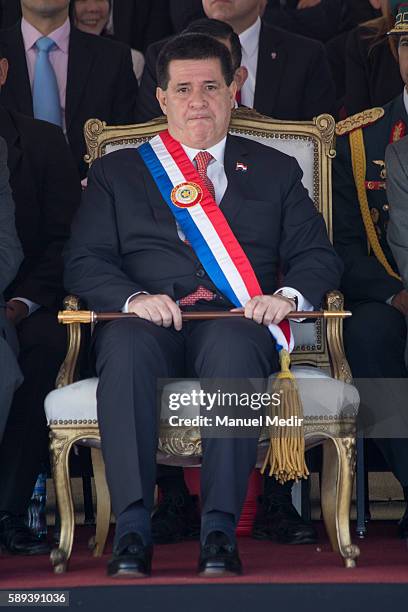 President of Paraguay, Horacio Cartes looks on during a military parade as a part of Paraguay National Holidays celebrations at Avenida costanera on...