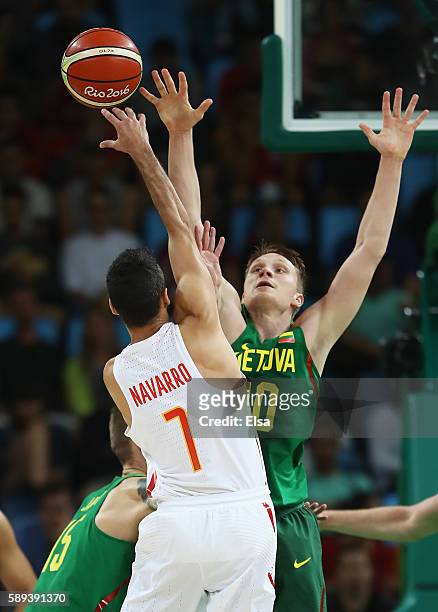 Renaldas Seibutis of Lithuania defends against Juan-Carlos Navarro of Spain during the Men's Preliminary Round Group B between Spain and Lithuania on...