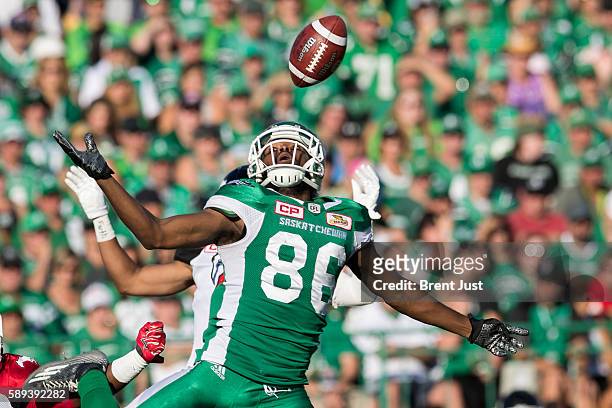 Joshua Stanford of the Saskatchewan Roughriders can't come down with the reception in the first half the game between the Calgary Stampeders and...