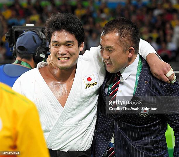 Ryunosuke Haga of Japan celebrates winning the bronze medal with his coach Keiji Suzuki after beating Artem Bloshenko of Ukraine during the men's...