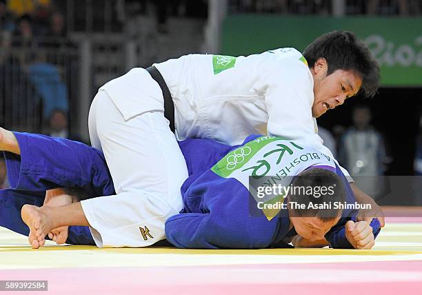 Ryunosuke Haga of Japan and Artem Bloshenko of Ukraine compete in the Men's -100kg bronze medal B contest on Day 6 of the 2016 Rio Olympics at...