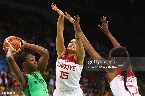 Clarissa Santos of Brazil drives past Tilbe Senyurek and Lara Sanders of Turkey during the Women's round Group A basketball match between Brazil and...