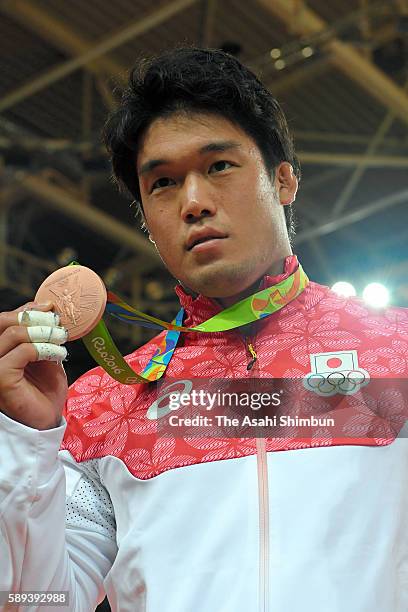 Bronze medalist Ryunosuke Haga of Japan poses for photographs after the medal ceremony for the men's -100kg on Day 6 of the 2016 Rio Olympics at...