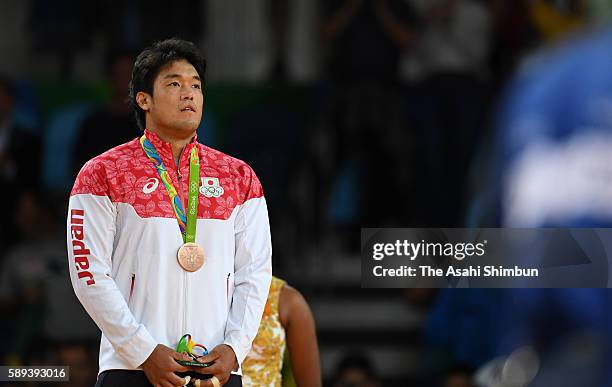 Bronze medalist Ryunosuke Haga of Japan stands on the podium at the medal ceremony for the men's -100kg on Day 6 of the 2016 Rio Olympics at Carioca...