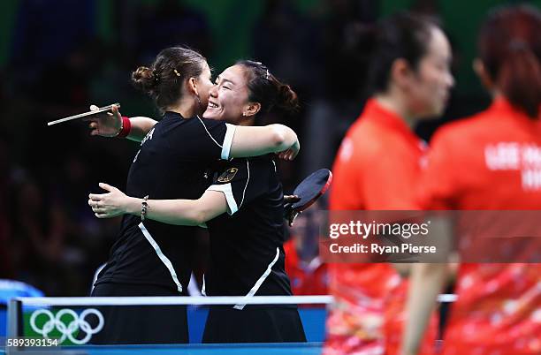 Petrissa Solja and Xiaona Shan of Germany celebrate after winning match point against Hong Kong during the Table Tennis Women's Team Round Quarter...