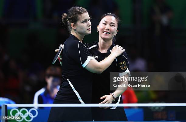 Petrissa Solja and Xiaona Shan of Germany celebrate after winning match point against Hong Kong during the Table Tennis Women's Team Round Quarter...