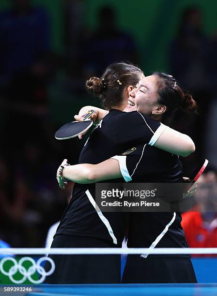 Petrissa Solja and Xiaona Shan of Germany celebrate after winning match point against Hong Kong during the Table Tennis Women's Team Round Quarter...
