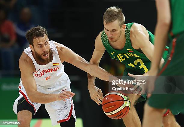 Sergio Rodriguez of Spain and Vaidas Kariniauskas of Lithuania go for the loose ball during the Men's Preliminary Round Group B between Spain and...