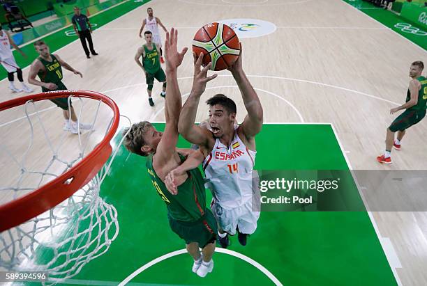 Guillermo Hernangomez Geuer of Spain goes to the basket against Mindaugas Kuzminskas of Lithuania during the Men's Preliminary Round Group B between...