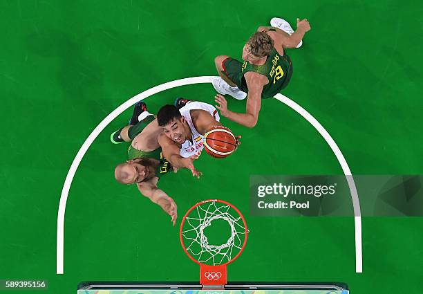 Guillermo Hernangomez Geuer of Spain goes to the basket against Antanas Kavaliauskas and Mindaugas Kuzminskas of Lithuania on Day 8 of the Rio 2016...