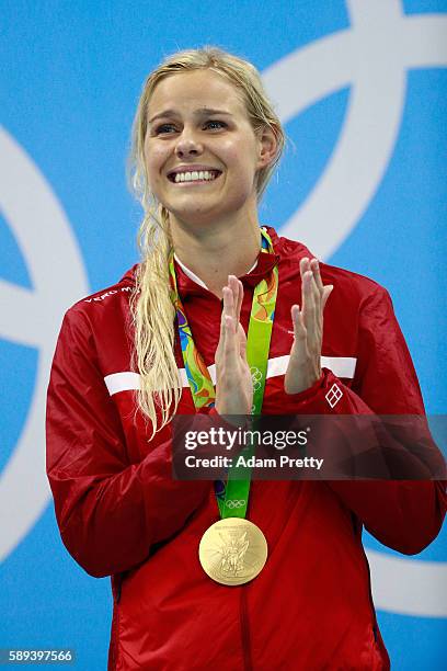 Gold medalist Pernille Blume of Denmark celebrates on the podium during the medal ceremony for the Women's 50m Freestyle Final on Day 8 of the Rio...