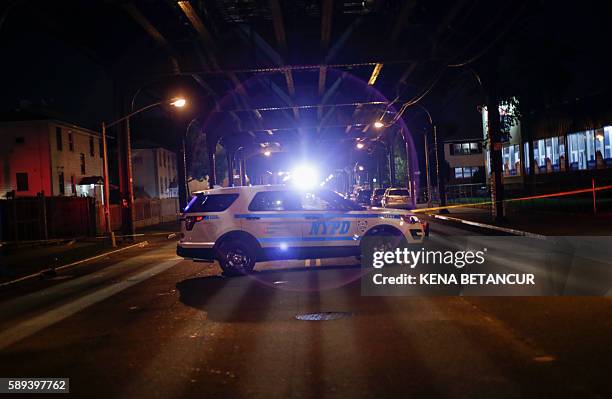 Car stand on the crime scene in Ozone Park after where Mosque leader Maulama Akonjee and friend Thara Uddin were killed in the Queens borough of New...