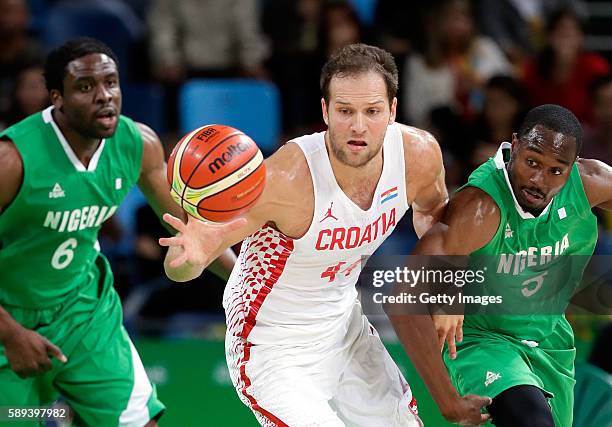 Bojan Bogdanovic of Croatia battles Ike Diogu and Michael Umeh of Nigeria for a loose ball during the preliminary round game at the Rio 2016 Olympic...