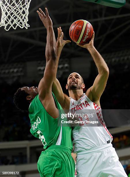 Zeljko Sakic of Croatia shoots as Ike Diogu of Nigeria defends during the preliminary round game at the Rio 2016 Olympic Games on August 13, 2016 in...