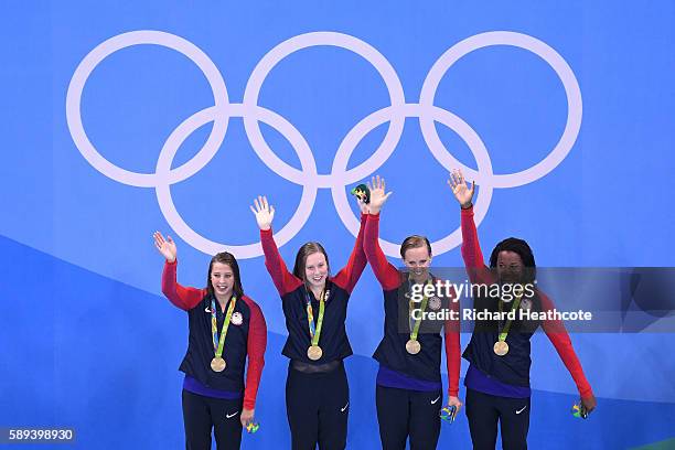 Kathleen Baker, Lilly King, Dana Vollmer, Simone Manuel of the United States celebrate on the podium during the medal ceremony for the Women's 4 x...