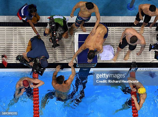 Nathan Adrian, Ryan Murphy, Michael Phelps and Cody Miller of the United States celebrate winning gold in the Men's 4 x 100m Medley Relay Final on...