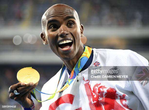 Britain's Mo Farah poses with his gold medal on the podium of the Men's 10,000m during the athletics event at the Rio 2016 Olympic Games at the...