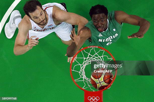 An overview shows Nigeria's power forward Ike Diogu and Croatia's centre Miro Bilan eye a rebound during a Men's round Group B basketball match...