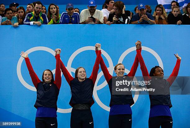 Kathleen Baker, Lilly King, Dana Vollmer, Simone Manuel of the United States celebrate on the podium during the medal ceremony for the Women's 4 x...