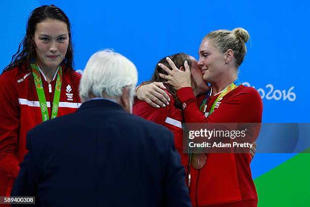 Bronze medalists Kylie Masse, Rachel Nicol, Penny Oleksiak and Chantal Van Landeghem of Canada celebrate on the podium during the medal ceremony for...