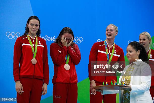 Bronze medalists Kylie Masse, Rachel Nicol, Penny Oleksiak and Chantal Van Landeghem of Canada celebrate on the podium during the medal ceremony for...