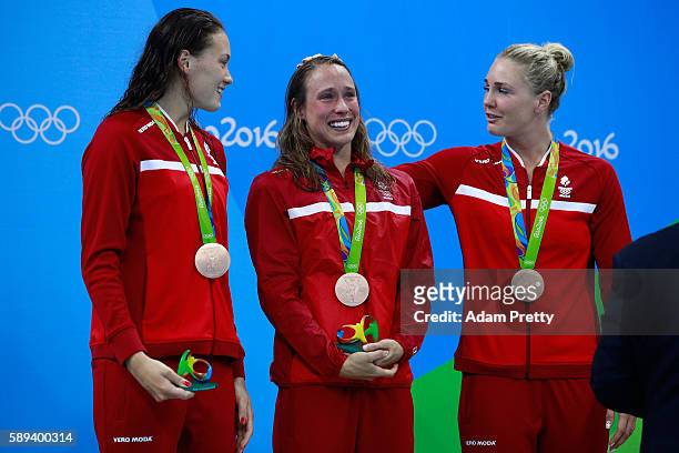 Bronze medalists Kylie Masse, Rachel Nicol, Penny Oleksiak and Chantal Van Landeghem of Canada celebrate on the podium during the medal ceremony for...