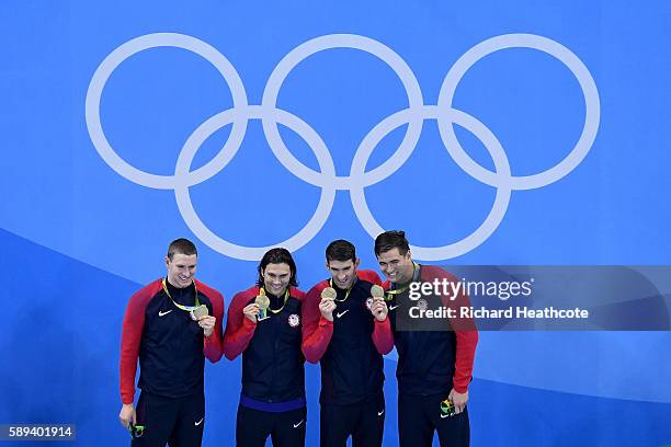 Gold medalists Ryan Murphy, Cody Miller, Michael Phelps and Nathan Adrian of the United States pose on the podium during the medal ceremony for the...
