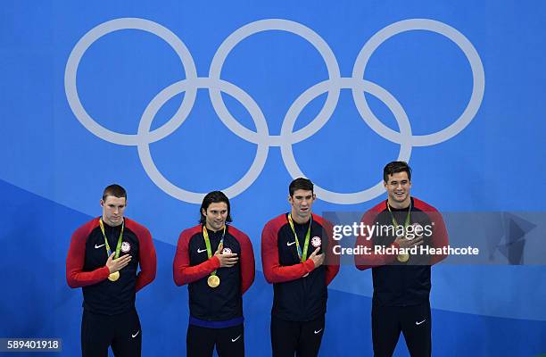 Gold medalists Ryan Murphy, Cody Miller, Michael Phelps and Nathan Adrian of the United States pose on the podium during the medal ceremony for the...