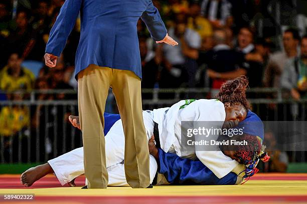 With the referee signalling a hold, Emilie Andeol of France holds defending champion, Idalys Ortiz of Cuba, for an ippon to win the o78kg gold medal...