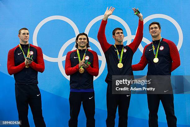 Gold medalists Ryan Murphy, Cody Miller, Michael Phelps and Nathan Adrian of the United States pose on the podium during the medal ceremony for the...