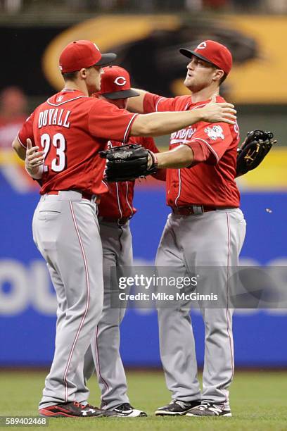 Adam Duvall of the Cincinnati Reds Scott Scheduler and Tyler Holt celebrate after the 11-5 win over the Milwaukee Brewers at Miller Park on August...