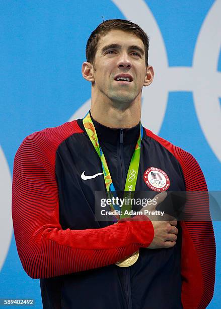 Gold medalist Michael Phelps of the United States poses on the podium during the medal ceremony for the Men's 4 x 100m Medley Relay Final on Day 8 of...