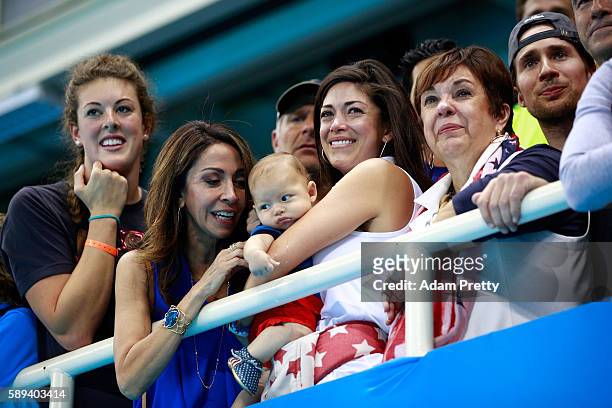 Allison Schmitt, Nicole Johnson, fiancee of Michael Phelps of the United States, holds their son Boomer and Debbie Phelps, Michael's mother,...
