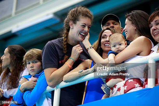 Allison Schmitt and Nicole Johnson, fiancee of Michael Phelps of the United States (holding their son Boomer( celebrate after the Men's 4 x 100m...