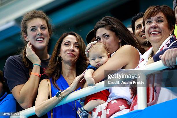 Allison Schmitt, Nicole Johnson, fiancee of Michael Phelps of the United States, and Debbie Phelps, Michael's mother, celebrate after the Men's 4 x...