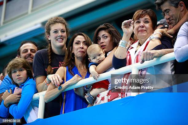 Allison Schmitt, Nicole Johnson, fiancee of Michael Phelps of the United States, holds their son Boomer and Debbie Phelps, Michael's mother,...