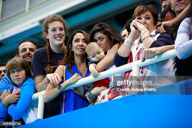 Allison Schmitt, Nicole Johnson, fiancee of Michael Phelps of the United States, holds their son Boomer and Debbie Phelps, Michael's mother,...