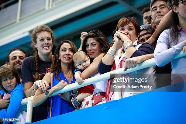 Allison Schmitt, Nicole Johnson, fiancee of Michael Phelps of the United States, holds their son Boomer and Debbie Phelps, Michael's mother,...