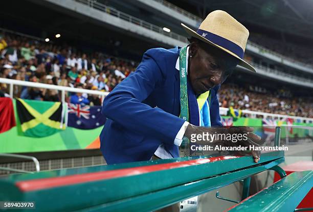 Technical official Laura Das Chagas prepares takeoff boards during the competes in the Men's Long Jump final on Day 8 of the Rio 2016 Olympic Games...