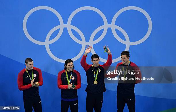 Gold medalists Ryan Murphy, Cody Miller, Michael Phelps and Nathan Adrian of the United States celebrate on the podium during the medal ceremony for...